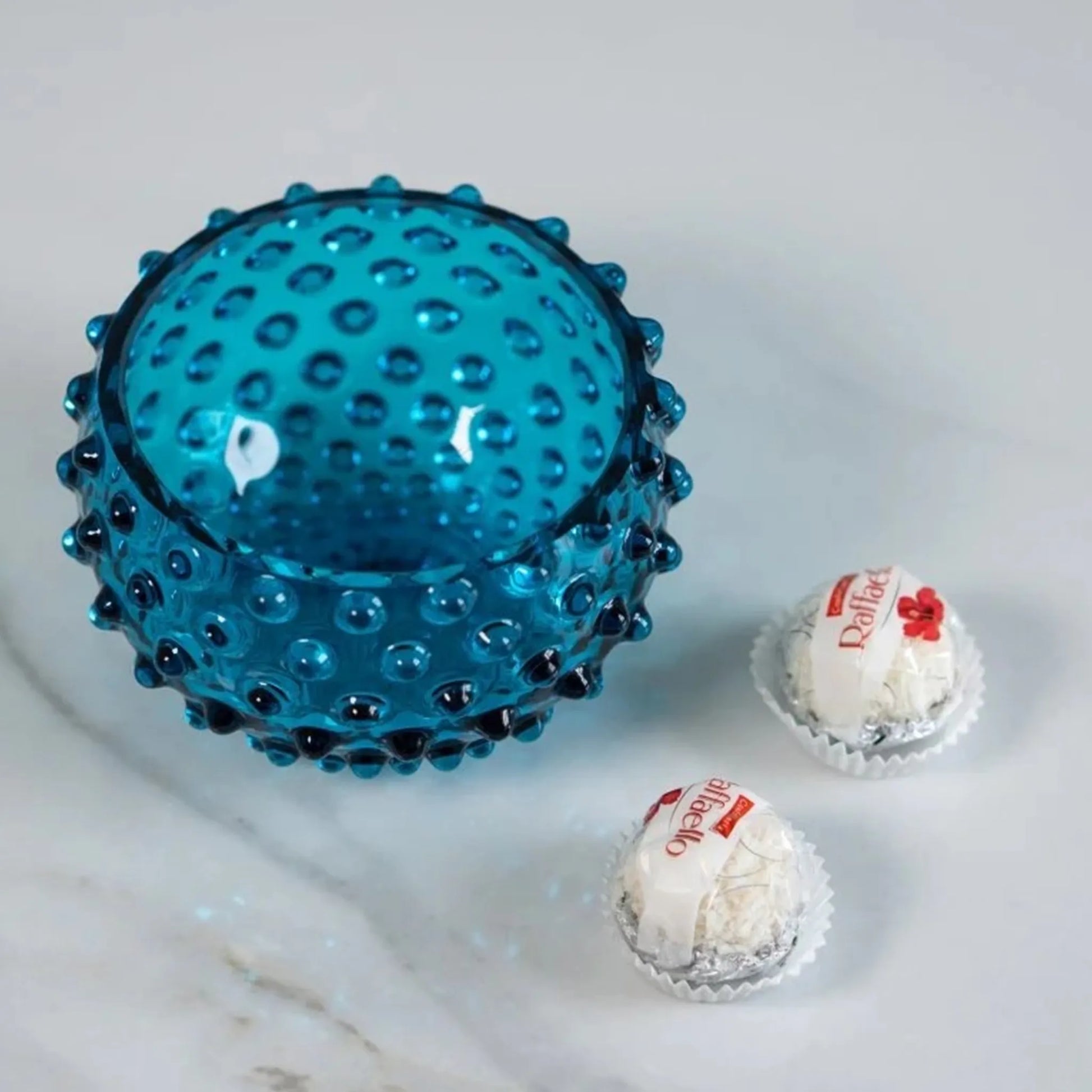 Bowl Hobnail Aquamarine ambientado em mesa de pedra ao lado de doces.