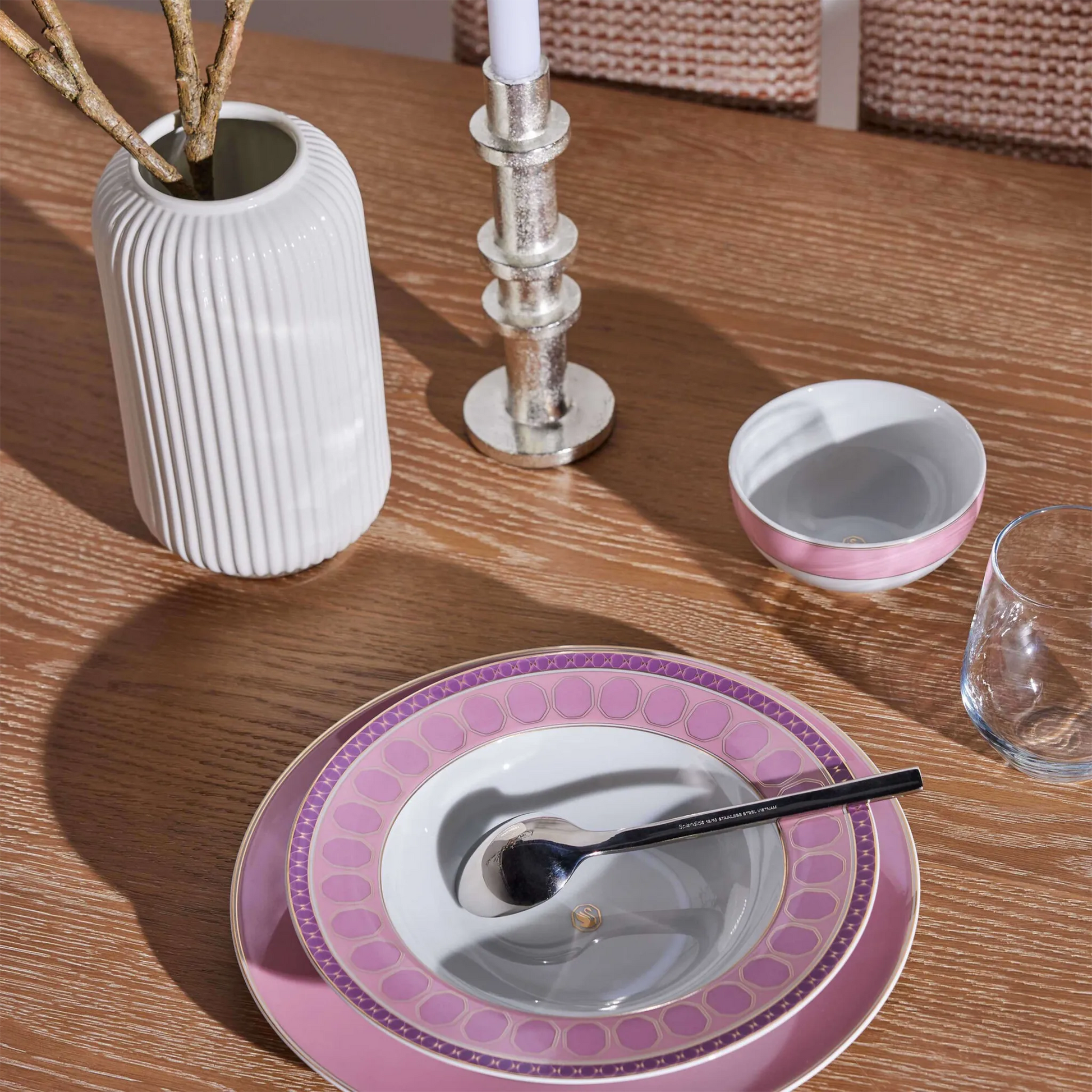 Conjunto de aparelhos de jantar Swarovski Rosa em mesa de madeira.