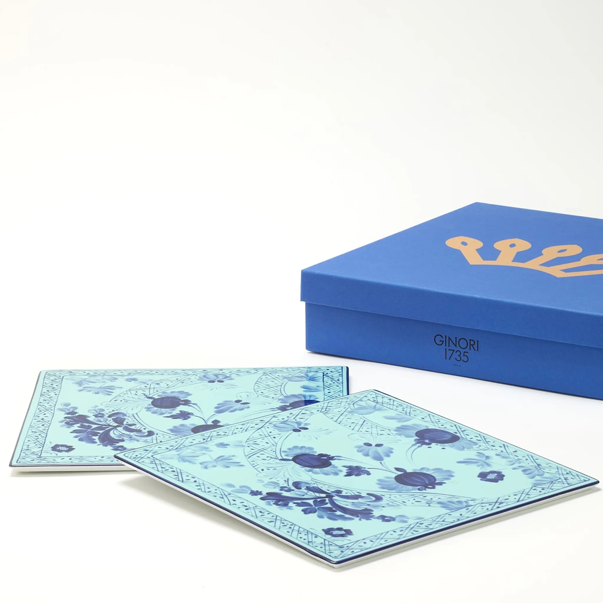 Set Sousplat Quadrado Tresori Íris com caixa ao lado.